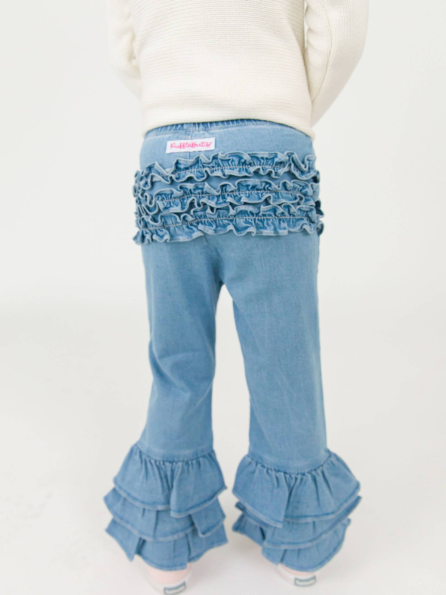 RuffleButts + RuggedButts - Toddler Girls Light Wash Denim Denim Ruffle Flare Pants with Signature Rear Ruffles